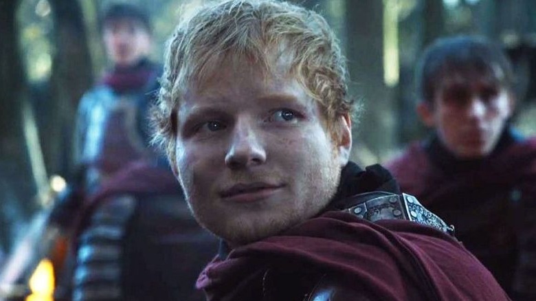 Ed Sheeran donning middle ages armor looks back