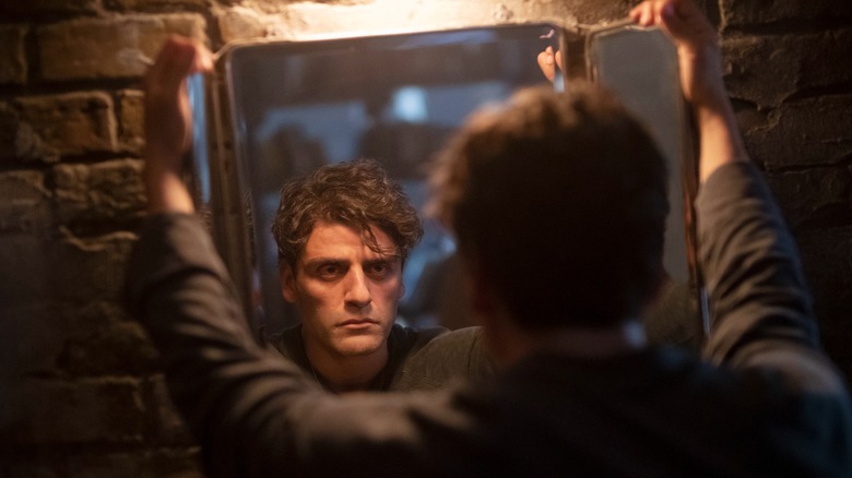 Oscar Isaac looking in the mirror in "Moon Knight"