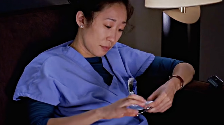 Cristina Yang sitting in armchair