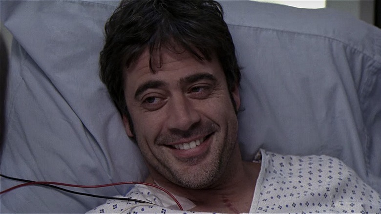 Denny grinning in a hospital bed