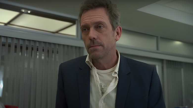 Dr. House looking ahead with shirt unbuttoned