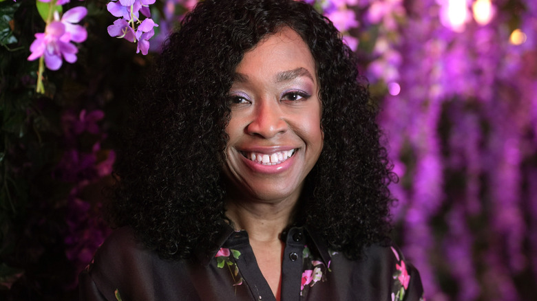 Shonda Rhimes smiles near flowers