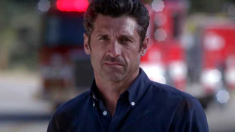 Derek Shepherd standing near fire truck