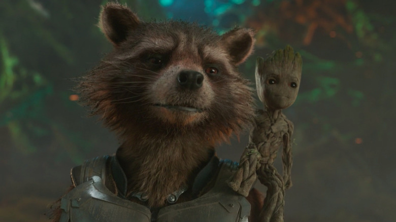 Rocket smiling while Baby Groot stands on his shoulder