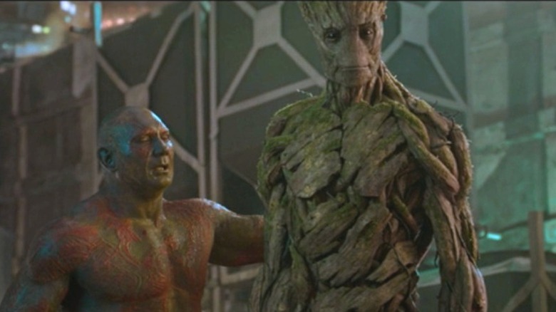 Drax puts his arm on Groot's back