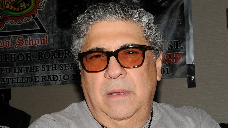 Vincent Pastore regards the camera from behind tinted glasses