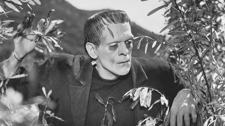 Frankenstein looking from behind a tree