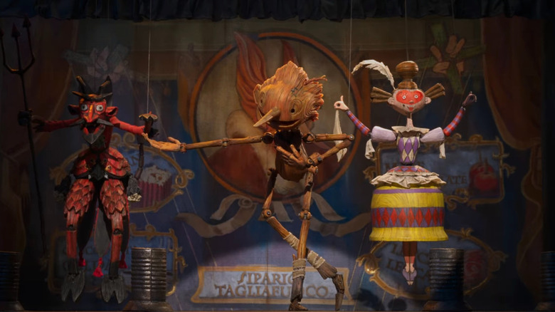 Pinocchio bowing with other puppets