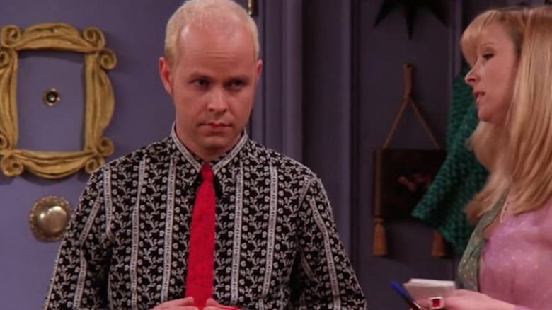 Gunther angry and wearing a red tie, Phoebe on the right