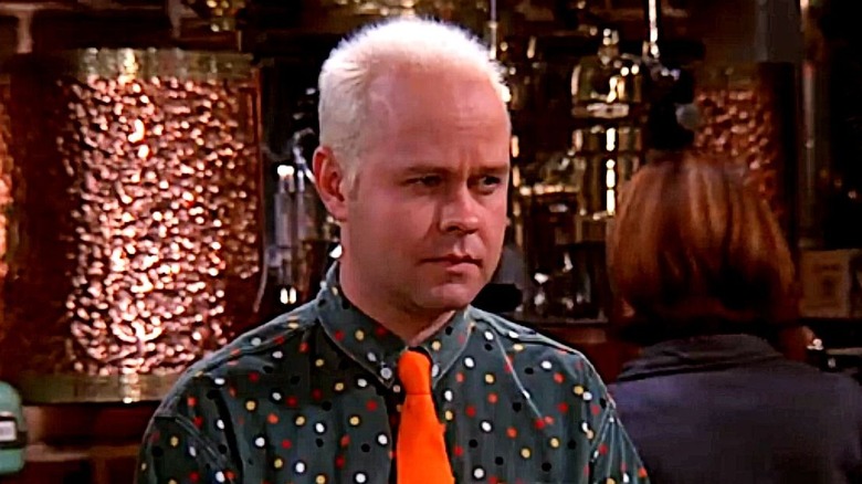 Gunther in a polka-dot shirt and orange tie