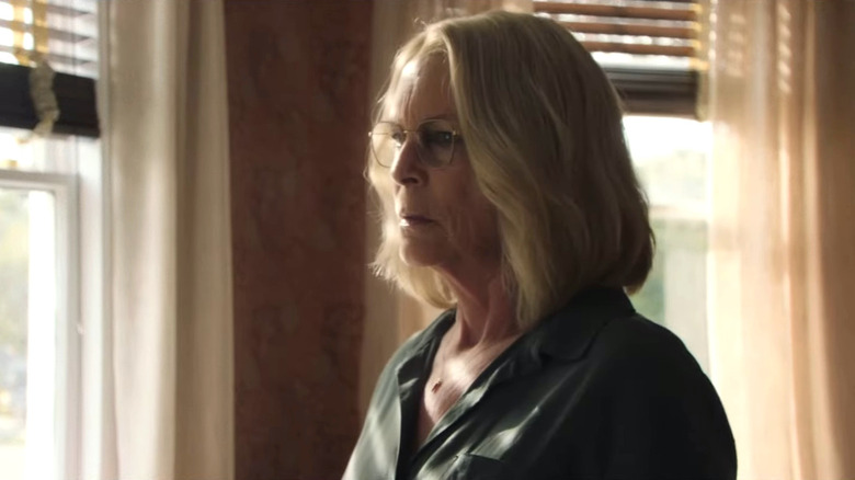 Older Laurie Strode looking out window