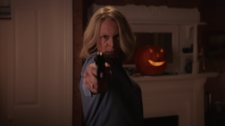 Laurie strode aims a gun with a determined expression