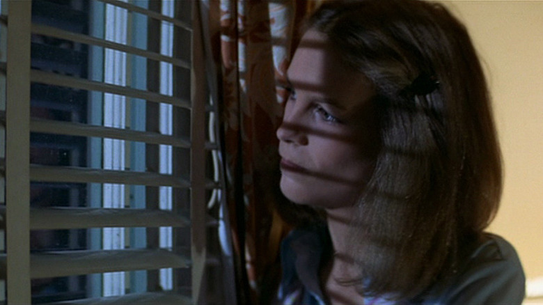 Laurie Strode looking through blinds