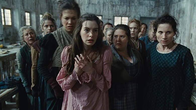 Fantine stands with factory women