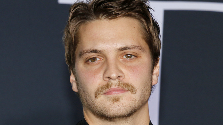 Luke Grimes with mustache at event