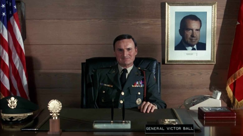 Charles Tyner smiles at his desk