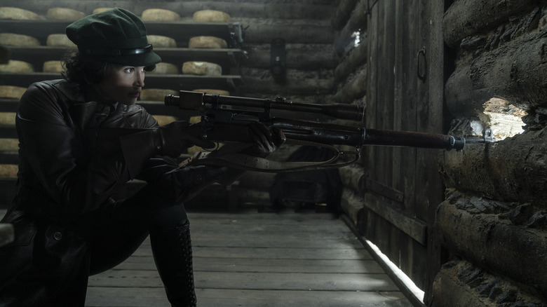 Polly Wilkins holding sniper rifle