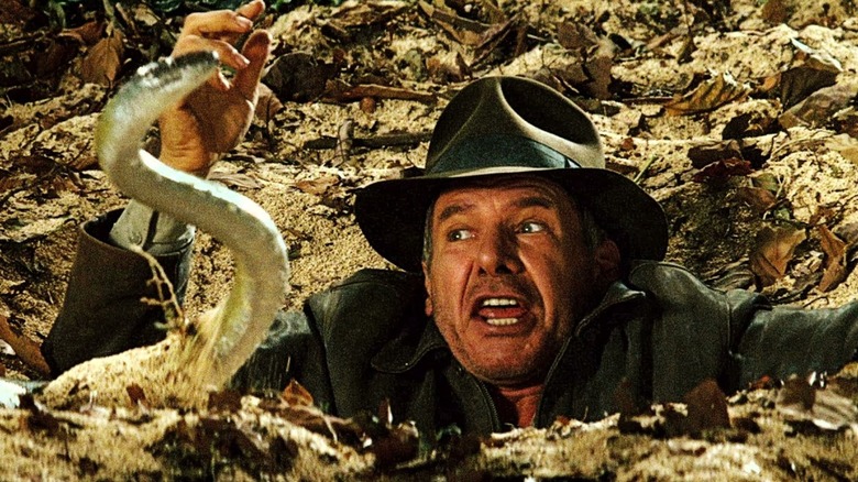 Indiana Jones in quicksand with snake