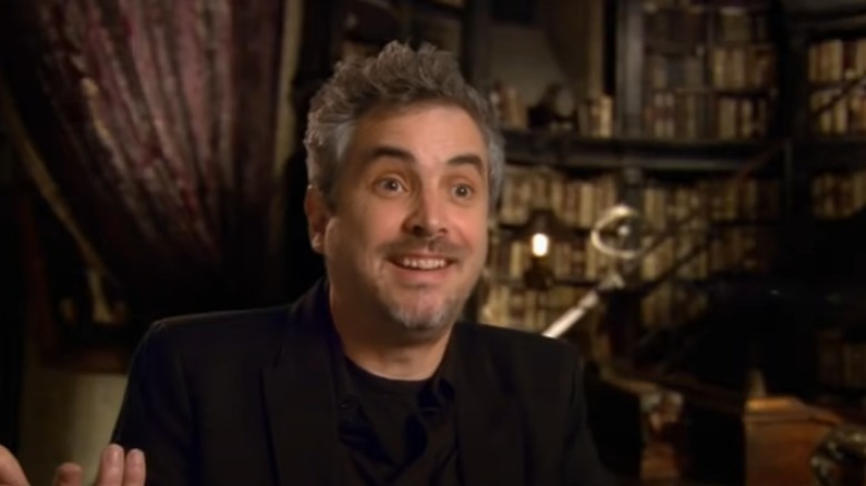 Alfonso Cuaron grinning and shrugging