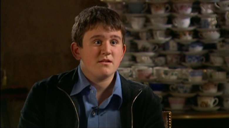 Harry Melling raising his eyebrows in surprise