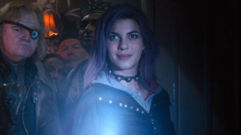 Tonks holding an illuminated wand