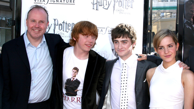 David Yates smiling with Rupert Grint, Daniel Radcliffe and Emma Watson