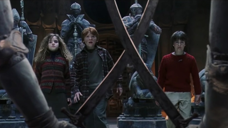 Hermione, Ron, and Harry playing life-size wizard chess