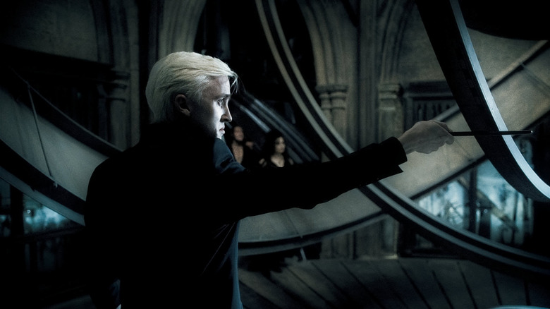 Draco in profile holding wand