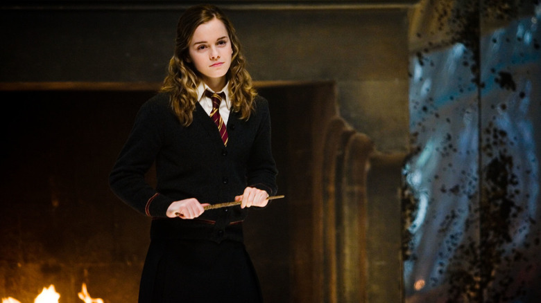 Hermione standing holding wand