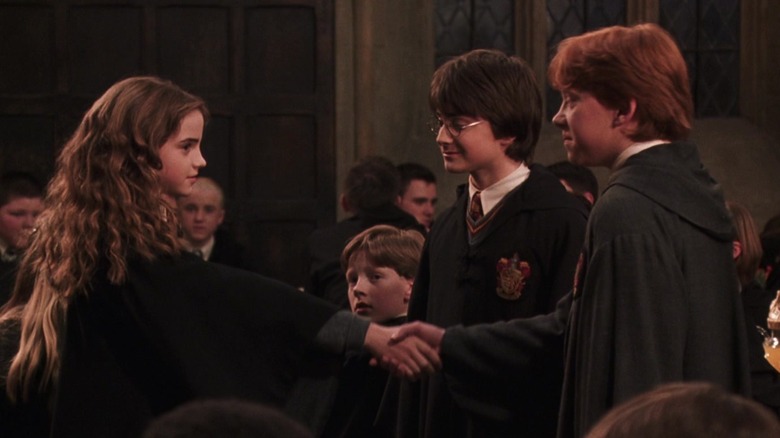 Hermione and Ron shaking hands