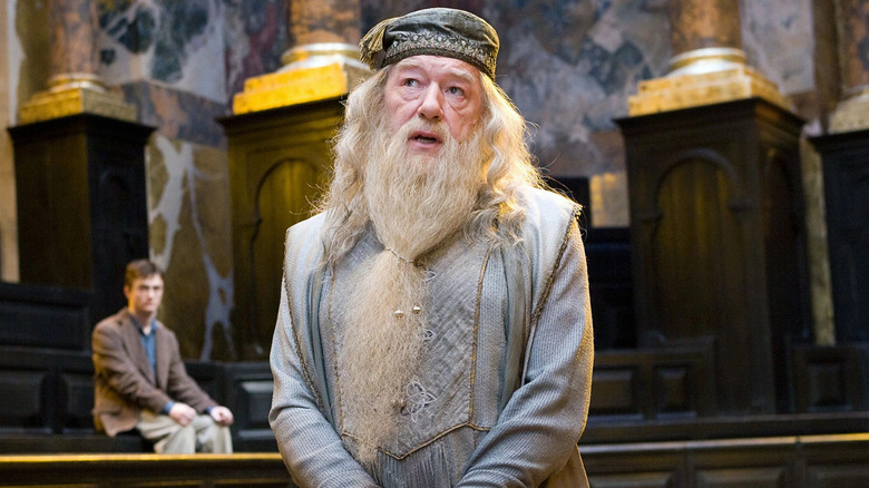 Dumbledore speaking Harry behind him