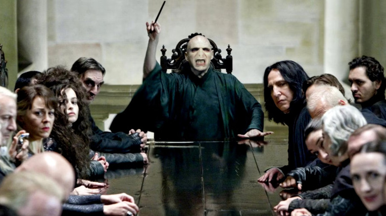 Voldemort at dining table raising wand