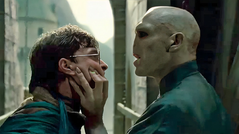 Voldemort holding Harry's face