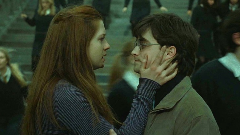 Ginny holding Harry's face