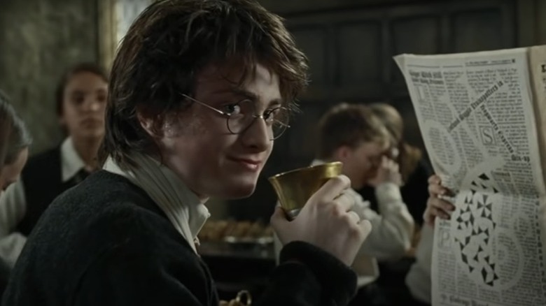 Harry Potter drinking from a glass