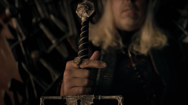 King Viserys  Targaryen holding a sword