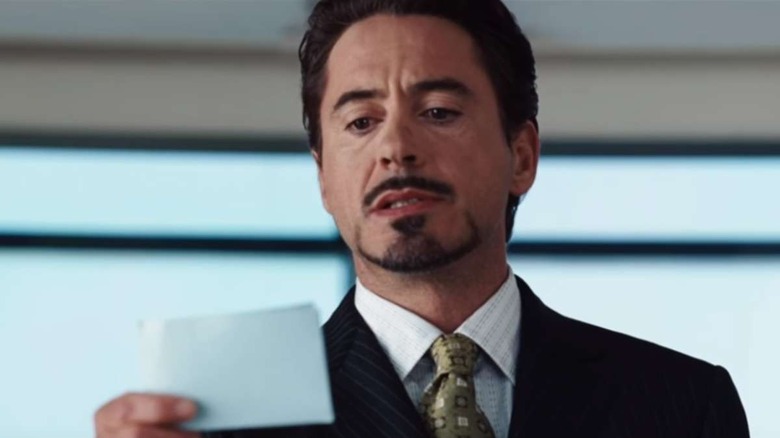 Tony Stark reads a note