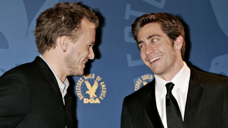 Heath Ledger and Jake Gyllenhaal smiling at each other