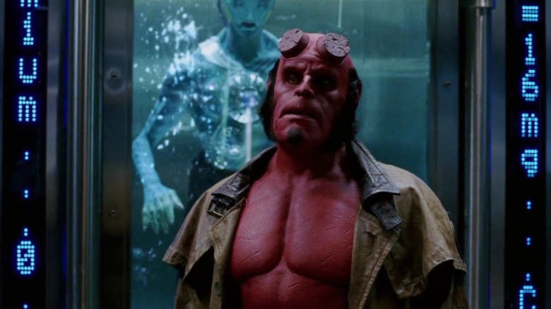 Hellboy standing in front of Abe Sapien looking upset 