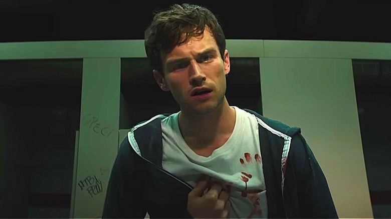 Brandon Flynn in a bathroom, looking confused