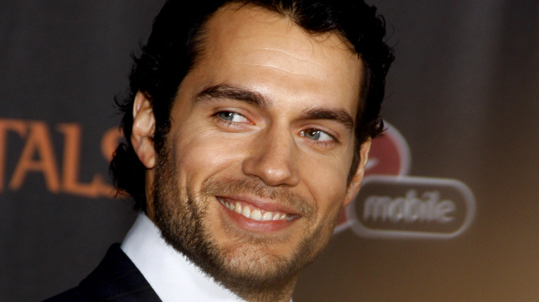 Henry Cavill smiling and looking off camera