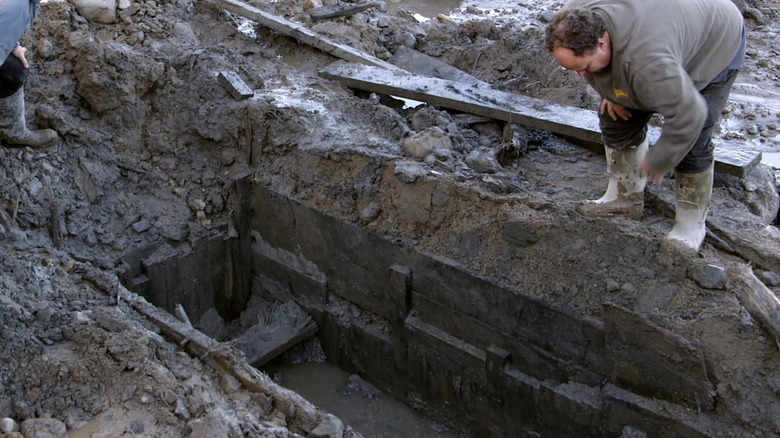 The crew inspects a dig on the Curse of Oak Island