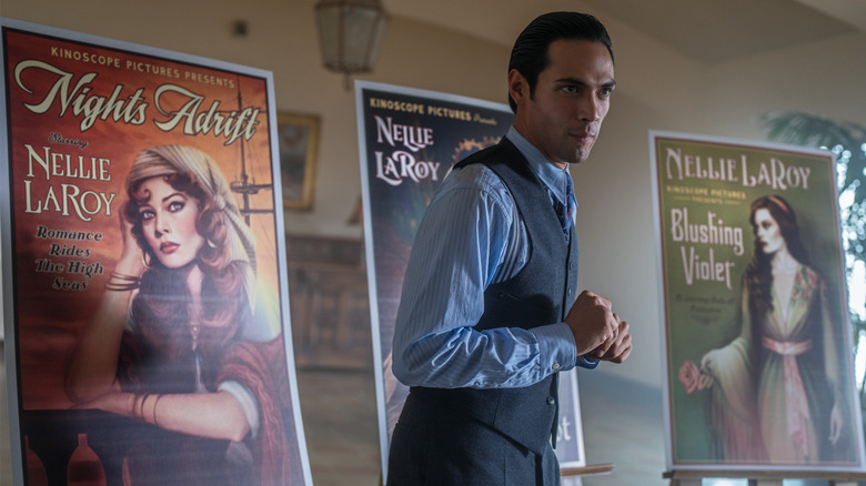 Manny Torres standing in front of movie posters