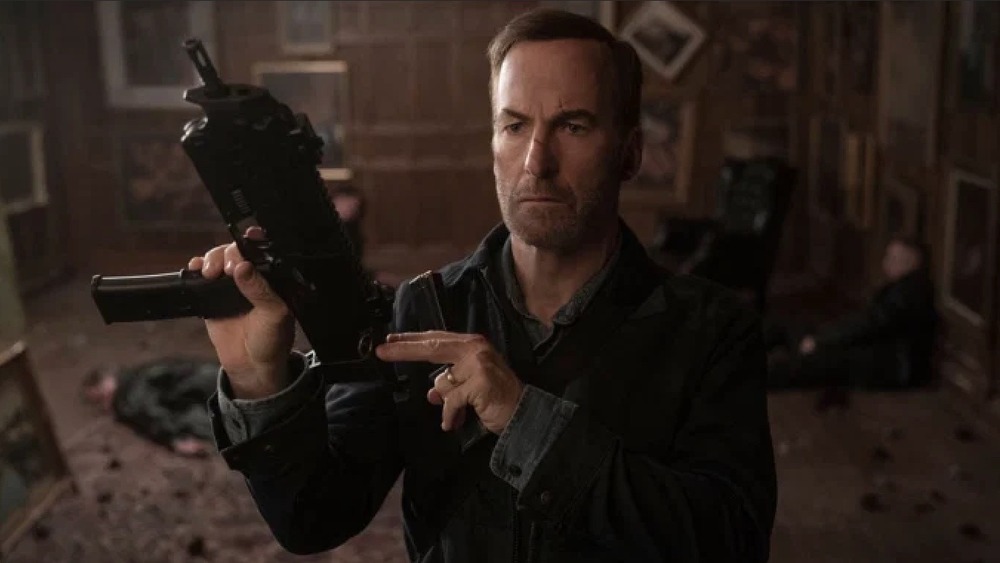 Odenkirk holding a gun