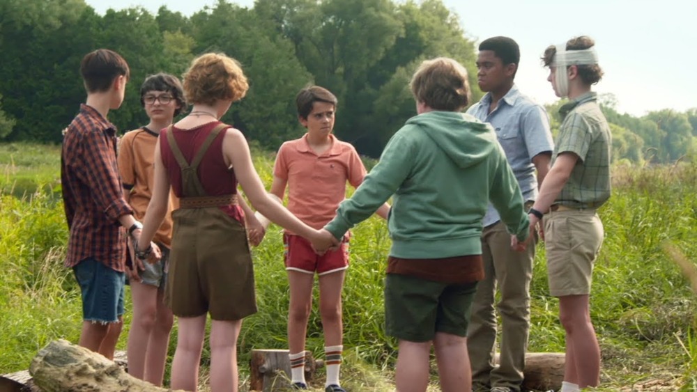 The Losers Club stands in a circle on It