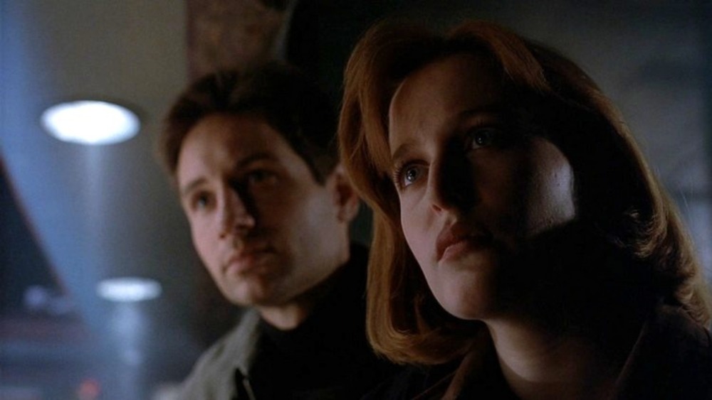 Mulder and Scully stare at someone