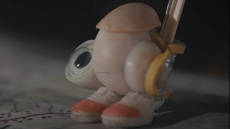 Marcel the Shell sitting on a map 