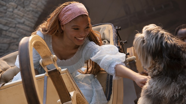 Ariel smiles as she pets Max