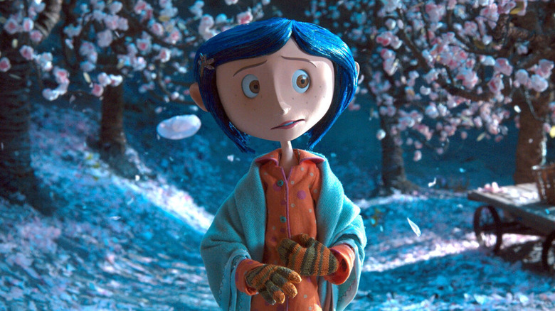 Coraline standing in snow wearing pajamas