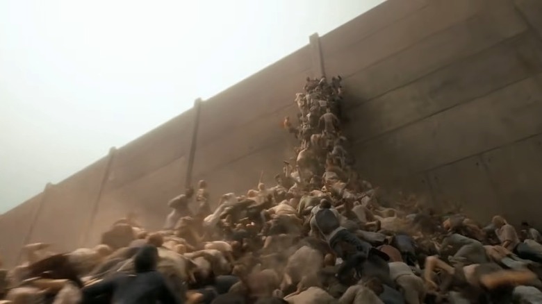 Zombies climbing a giant wall